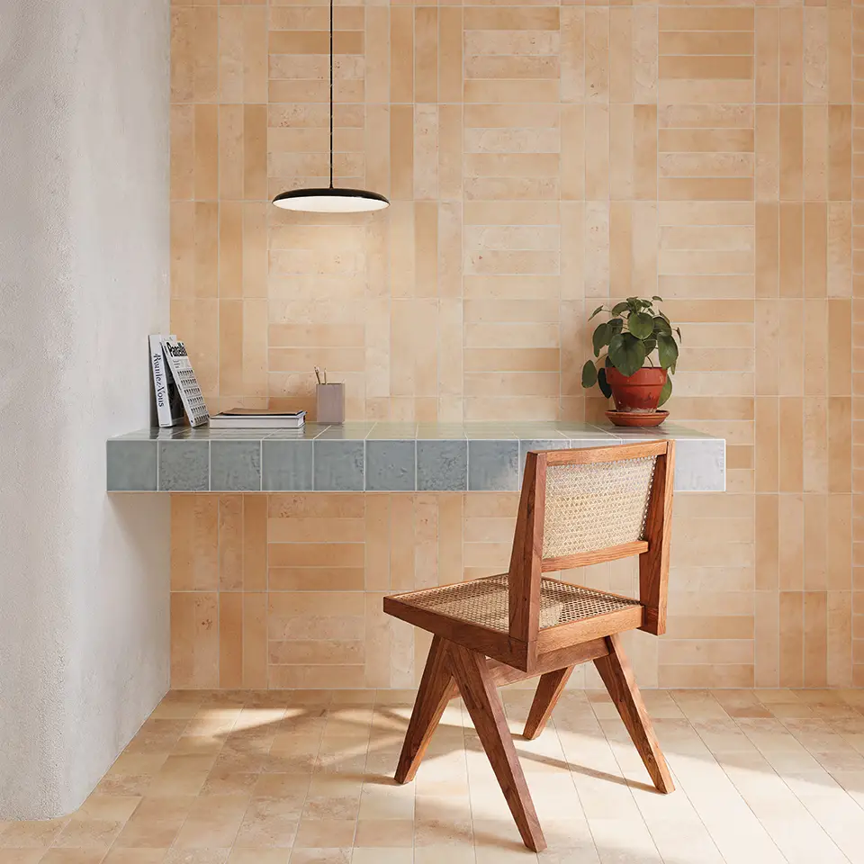 un bureau et une chaise face à un mur couleur terre en carrelage wow